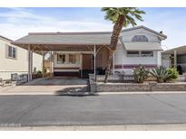 Charming home featuring a covered carport, desert landscaping, and a welcoming facade at 111 S Greenfield Rd # 313, Mesa, AZ 85206