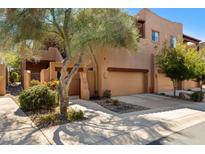 Inviting two-story home showcasing desert landscaping, private gate, and a convenient two-car garage at 13600 N Fountain Hills Blvd # 405, Fountain Hills, AZ 85268