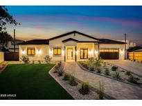 Stunning single-story home with professional landscaping, brick driveway, and welcoming modern curb appeal at 1506 E Tuckey Ln, Phoenix, AZ 85014