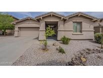 Inviting single-story home with neutral stucco exterior and desert landscaping, offering great curb appeal at 16526 W Calle Lejos --, Surprise, AZ 85387