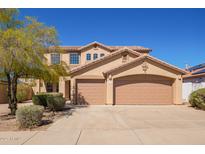 Beautiful two-story home with a three-car garage and desert landscaping at 17458 W Wandering Creek Rd, Goodyear, AZ 85338