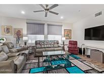 Inviting living room featuring comfortable seating, modern ceiling fan, and bright, neutral decor at 17850 N 68Th St # 1037, Phoenix, AZ 85054