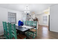 Inviting dining area with a rustic table, seating for eight, and bright lighting at 201 S Greenfield Rd # 255, Mesa, AZ 85206