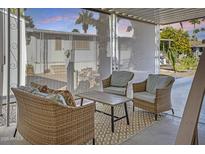 Inviting patio with comfortable wicker furniture, perfect for outdoor relaxation at 201 S Greenfield Rd # 255, Mesa, AZ 85206