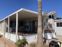 Charming home with covered porch, landscaping and clear skies at 2072 W Klamath Ave, Apache Junction, AZ 85119