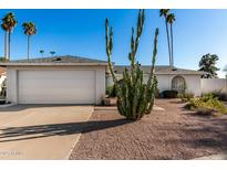 Charming single-story home featuring desert landscaping, a two-car garage, and a well-maintained facade at 2717 W Medina Ave, Mesa, AZ 85202
