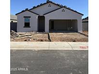 A single-story stucco house with an attached two-car garage featuring a tiled roof and low water use landscaping at 3945 E San Jose St, San Tan Valley, AZ 85143