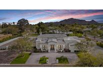 Stunning home featuring meticulous landscaping, lush greenery and a circular driveway for a grand arrival at 6129 E Turquoise Ave, Paradise Valley, AZ 85253