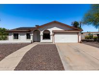 Charming single-story home featuring a two-car garage, low maintenance landscaping, and solar panels at 804 W Bentrup St, Chandler, AZ 85225