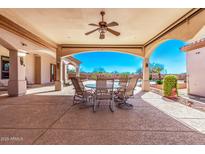 Outdoor patio boasting a dining area, overhead fan, and a picturesque view of the pool at 11440 S 194Th Dr, Buckeye, AZ 85326