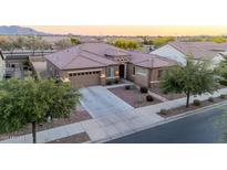 A well-manicured front yard complements this single-Gathering home with a three car garage and desert landscaping at 19011 E Carriage Way, Queen Creek, AZ 85142