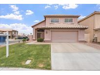 Charming two-story home showcasing a well-manicured lawn, a neutral palette, and a spacious two-car garage at 1520 E Flint St, Chandler, AZ 85225
