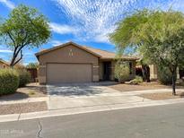Charming single-story home with a well-manicured front yard, desert landscaping, and a two-car garage at 4119 E Sundance Ave, Gilbert, AZ 85297