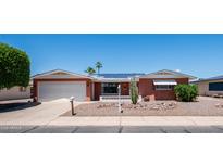 Charming home featuring desert landscaping, solar panels, and an attached two-car garage at 6258 E Duncan St, Mesa, AZ 85205