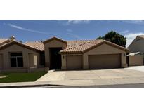 Charming one-story home with tile roof, desert landscaping, and a two car garage at , Gilbert, AZ 85233
