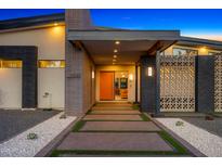 Inviting modern home entrance featuring decorative brickwork, concrete pathway, and desert landscaping at 11649 N Miller Rd, Scottsdale, AZ 85260