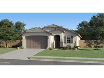 Charming single-story home featuring a two-car garage and inviting front yard with fresh landscaping at 12427 E Wallflower Ln, Florence, AZ 85132