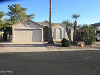 Inviting single-story home featuring a neutral color scheme, low maintenance landscaping, and an attached two-car garage at 1912 E Doral Dr, Chandler, AZ 85249