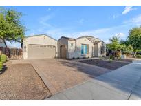 Charming single story home featuring a three car garage and desert landscaping at 21325 S 201St Way, Queen Creek, AZ 85142