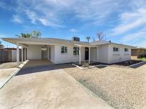 Charming single-story home featuring a covered carport, low maintenance landscaping, and freshly painted white exterior at 2201 W Avalon Dr, Phoenix, AZ 85015