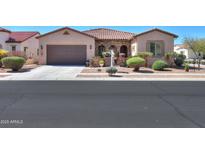 Charming single-Gathering home with a well-manicured front yard, desert landscaping, and a two-car garage at 2623 E Marcos Dr, Casa Grande, AZ 85194