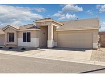Inviting single-story home boasts a neutral palette, two-car garage, and well-maintained landscaping at 3321 N Silverado --, Mesa, AZ 85215