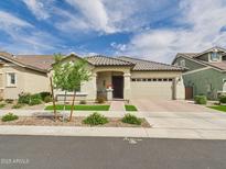 Charming single-story home with a well-manicured front yard, brick driveway, and a neutral color palette at 4164 E Bernice St, Gilbert, AZ 85295