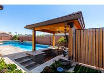 Outdoor kitchen with a built-in grill, sink, and bar, offering the ultimate outdoor living and entertaining experience at 45975 W Mountain View Rd, Maricopa, AZ 85139