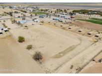 Expansive aerial view of the fenced property with stalls and plenty of open space at 49853 W Jean Dr, Maricopa, AZ 85139