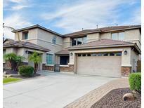 Charming two-story home featuring a large garage, desert landscaping and a paved driveway at 5622 W Cavedale Dr, Phoenix, AZ 85083