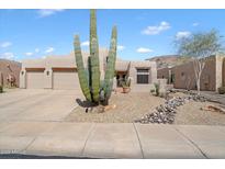 Contemporary home with a desert landscaped front yard and large Saguaro cactus at 6372 W Hill Ln, Glendale, AZ 85310