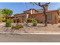 Charming single-Gathering home with a well-manicured front yard and gravel landscaping at 7600 E Golden Eagle Cir, Gold Canyon, AZ 85118