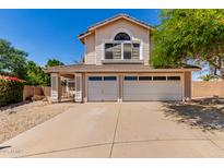 Charming two-story home featuring a three-car garage, covered porch, and well-maintained landscaping at 4302 E Mountain Vista Dr, Phoenix, AZ 85048