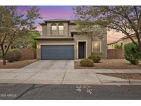 Charming two-story home with a well-maintained front yard and a two-car garage at 15758 W Cortez St, Surprise, AZ 85379
