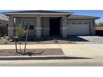 Charming single-story home featuring a well-manicured lawn and a paved driveway leading to an attached garage at 21829 E Bonanza Ct, Queen Creek, AZ 85142