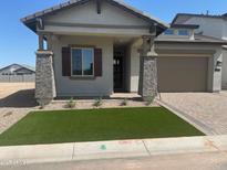Charming single-Gathering home featuring a two-car garage and an inviting front porch with stone accents at 3638 E Roland St, Mesa, AZ 85213