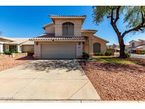 Charming two-story home featuring a neutral stucco exterior, tile roof, and a spacious two-car garage at 13711 N 81St Ave, Peoria, AZ 85381