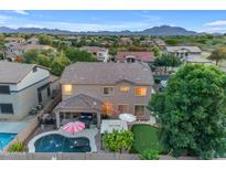 Aerial view of large home showcasing the backyard with pool, patio, putting green, and seating areas at 18460 E Peachtree Blvd, Queen Creek, AZ 85142