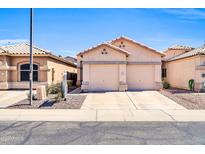 Charming single-story home with a two-car garage and well-maintained desert landscaping under a clear, sunny sky at 19815 N 49Th Ave, Glendale, AZ 85308