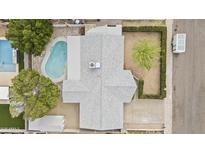 Aerial view of a home with a backyard pool, shed and patio surrounded by mature trees and greenery at 3802 W Rue De Lamour Ave, Phoenix, AZ 85029