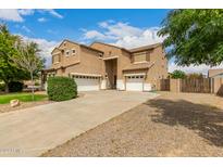 Spacious two-story home with a three-car garage and extended driveway on a sunny day at 38397 N Nuevo Laredo Ln, San Tan Valley, AZ 85140