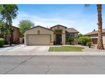 Charming single-Gathering home featuring a two-car garage, desert landscaping, and a cozy front entrance at 384 N Scott Dr, Chandler, AZ 85225