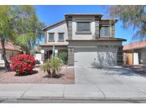 Inviting two-story home featuring a well-manicured lawn and attached two-car garage at 45176 W Alamendras St, Maricopa, AZ 85139