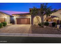 Charming home featuring a brick-accented facade, a paver driveway, and a well-maintained landscaped front yard at 8661 E Ivy St, Mesa, AZ 85207