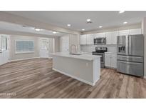 Bright kitchen features a large island, stainless steel appliances, and stylish white cabinetry at 1112 W Farmdale Ave, Mesa, AZ 85210