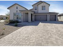 Charming two-story home featuring a three-car garage and a welcoming entrance at 11663 W Luxton Ln, Avondale, AZ 85323