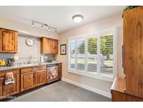 Bright kitchen with granite countertops and custom-painted dishwasher at 17885 N 99Th Dr, Sun City, AZ 85373