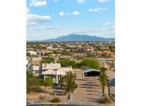 Aesthetic aerial shot of a desert home featuring mountain views and a meticulously maintained yard at 20041 W Pasadena Ave, Litchfield Park, AZ 85340