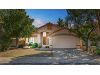 Charming single-story home with a two-car garage and lush landscaping at 2313 E Gondola Ln, Gilbert, AZ 85234