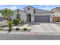 Charming stucco home featuring a tile roof, arched entry, and a well-manicured front yard at 24540 N 144Th Ave, Surprise, AZ 85387